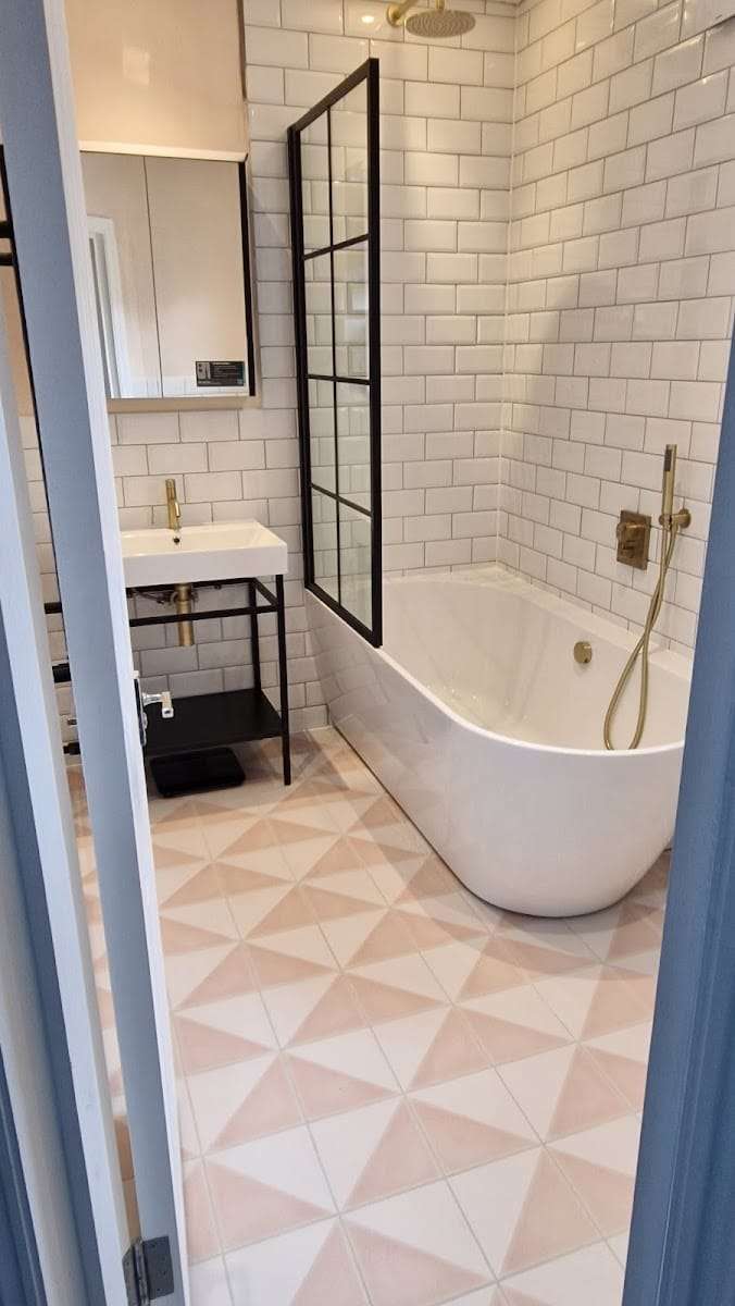 Metro tiled bathroom with freestanding bath, by R Construction Ltd